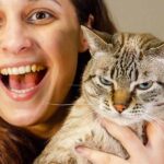 why does my cat growl when i pick her up